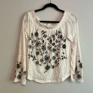 Scoop next or off shoulder embroidered tissue tee.